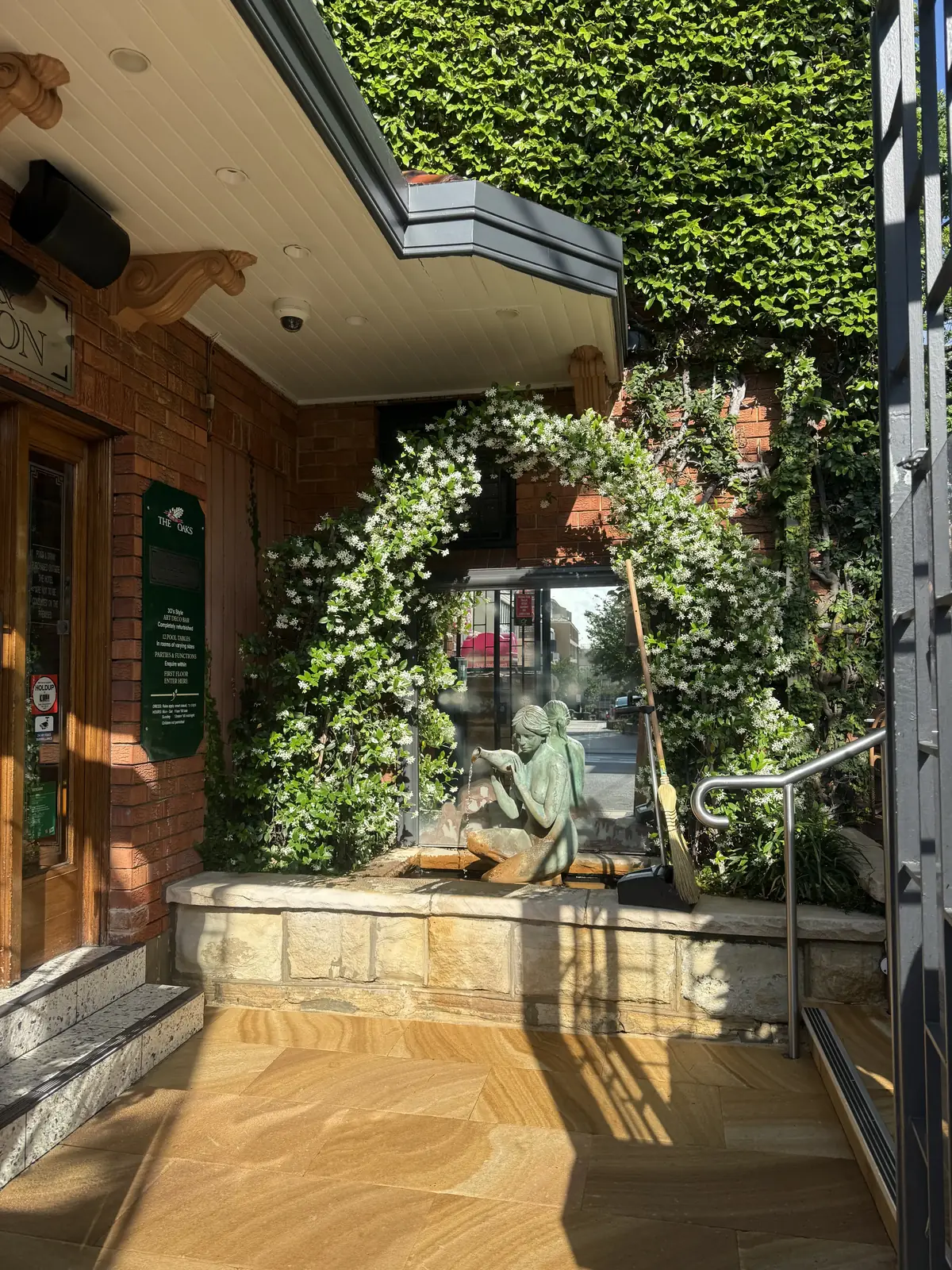 Landscaping in Parramatta — commercial entry garden with climbing greenery and sandstone